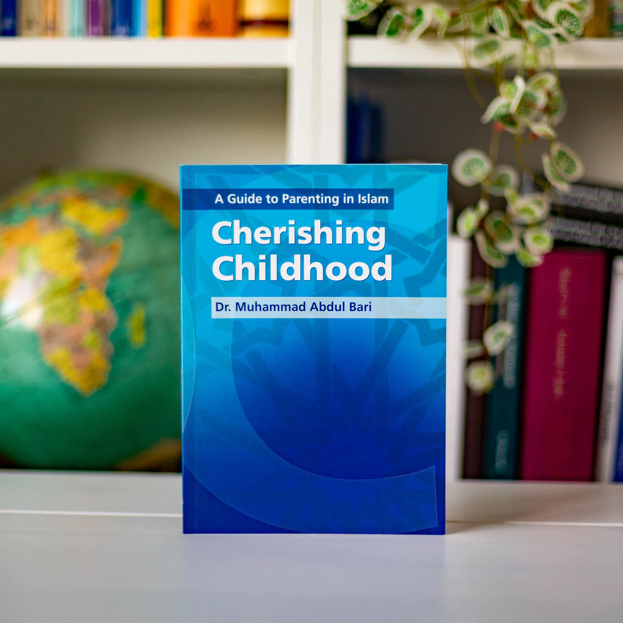 Upright book in library of Cherishing Childhood by Muhammad Abdul Bari. Muslim parenting guide by Ta-Ha Publishers