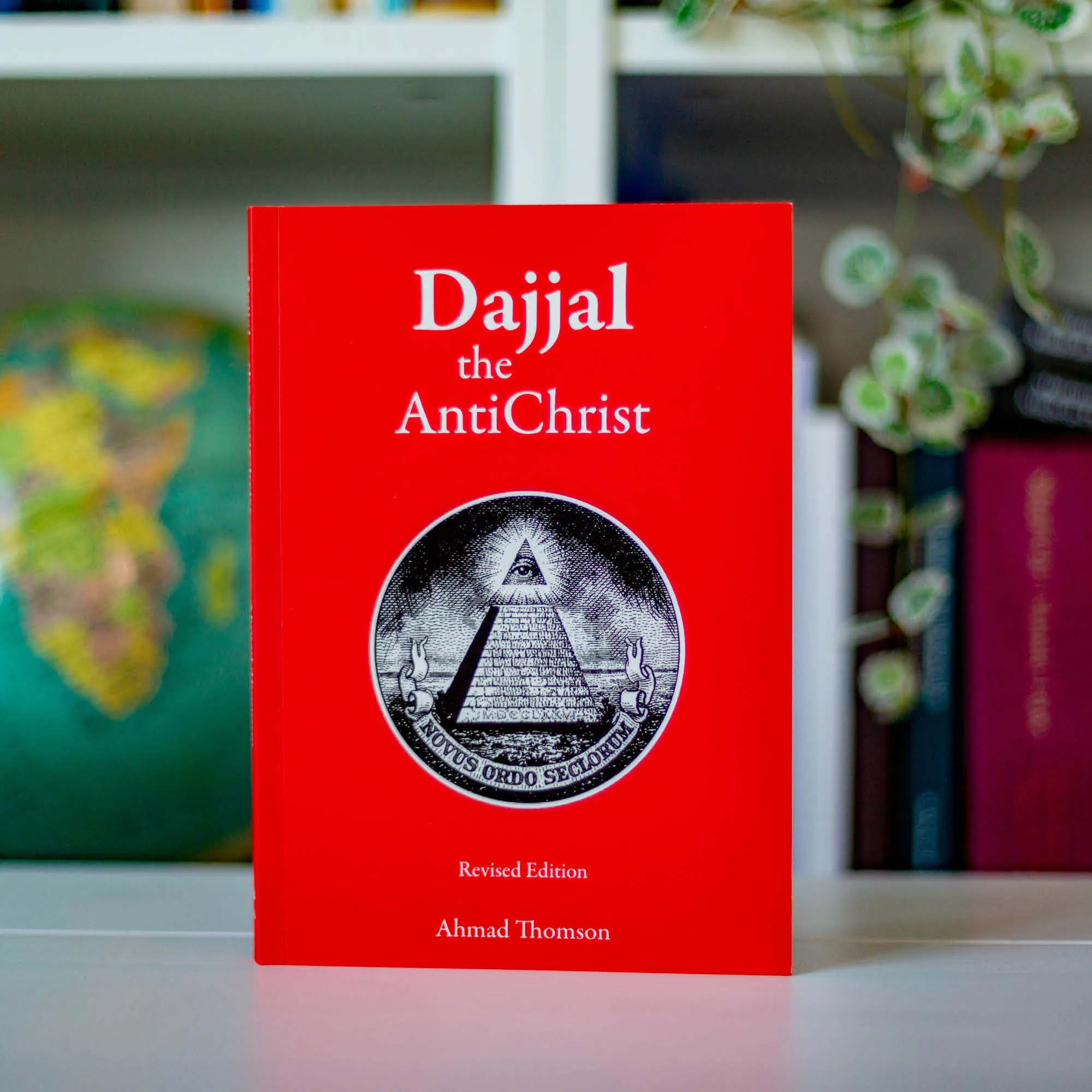Upright book in library of Dajjal the AntiChrist by Ahmad Thomson. Commentary on modern world order by Ta-Ha Publishers