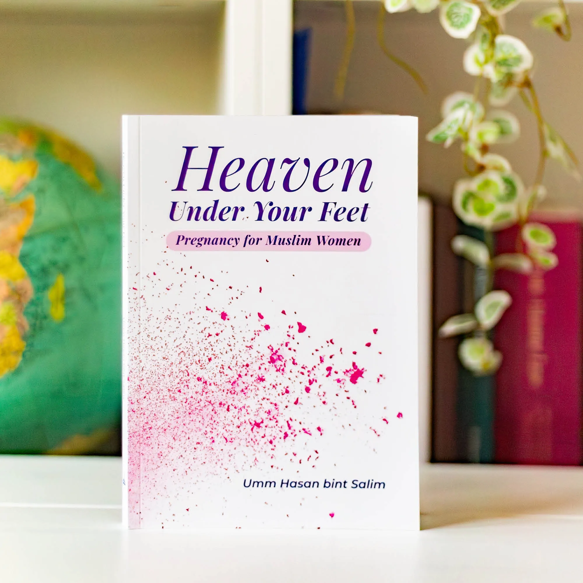 Upright book in library of Heaven Under Your Feet by Umm Hasan Bint Salim. Muslim pregnancy handbook by Ta-Ha Publishers