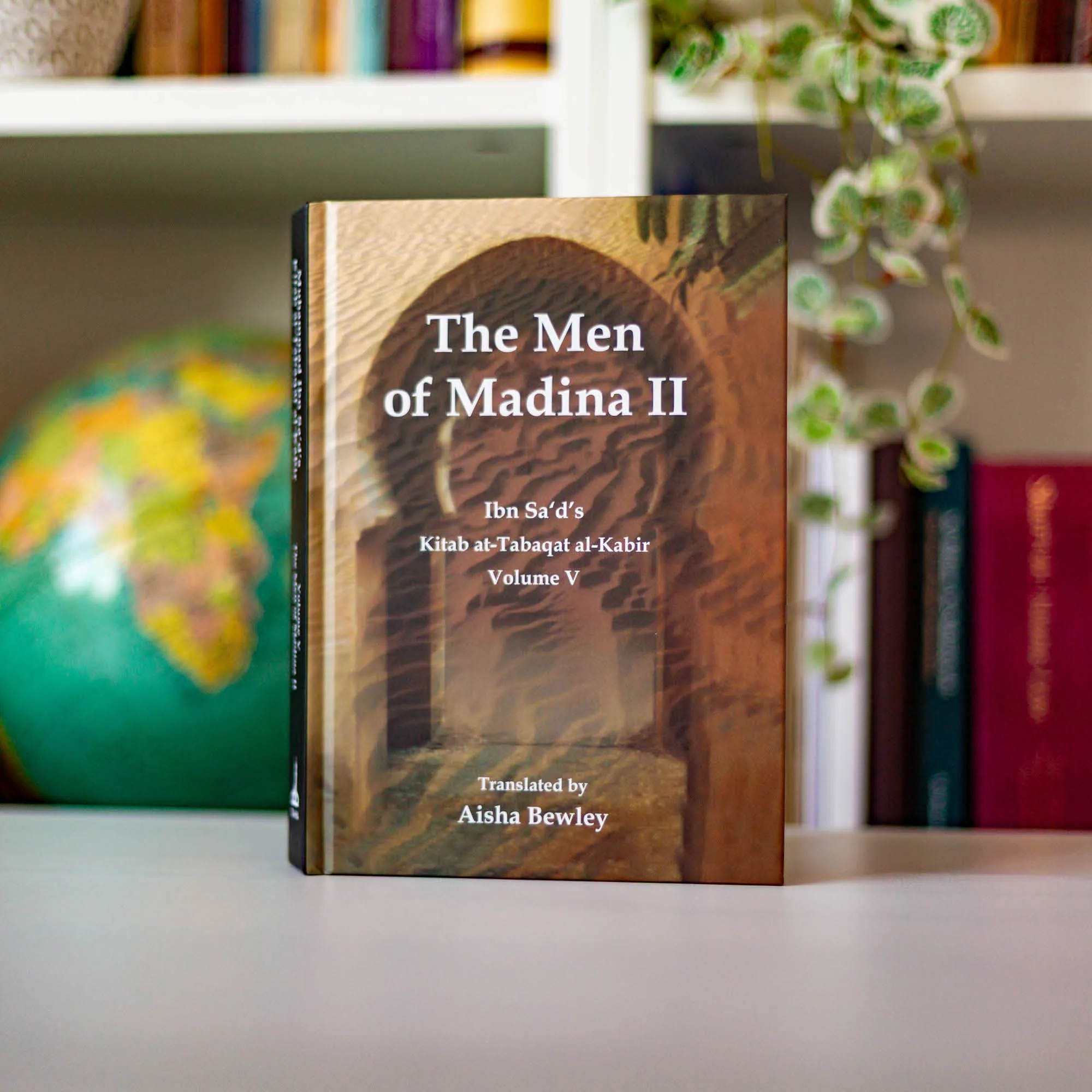 Upright book in library of The Men of Madina II by Muhammad Ibn Sa’d, Aisha Bewley. Kitab at-Tabaqat by Ta-Ha Publishers