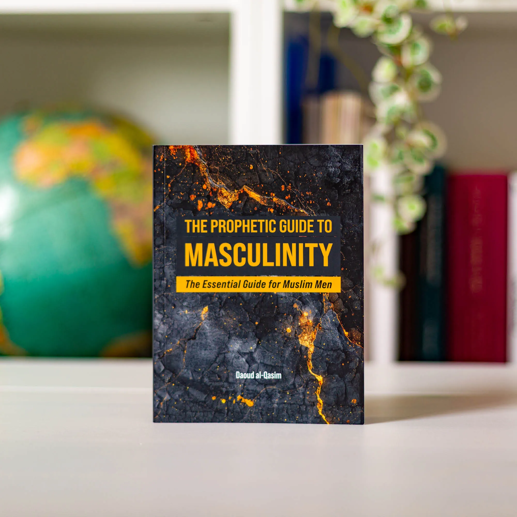 Upright book in library of The Prophetic Guide to Masculinity by Daoud al-Qasim. Masculinity handbook by Ta-Ha Publishers